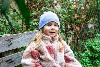 Portrait of young girl wearing warm clothing standing outdoors