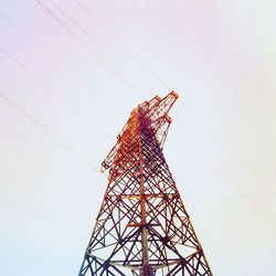 Low angle view of electricity pylon against clear sky