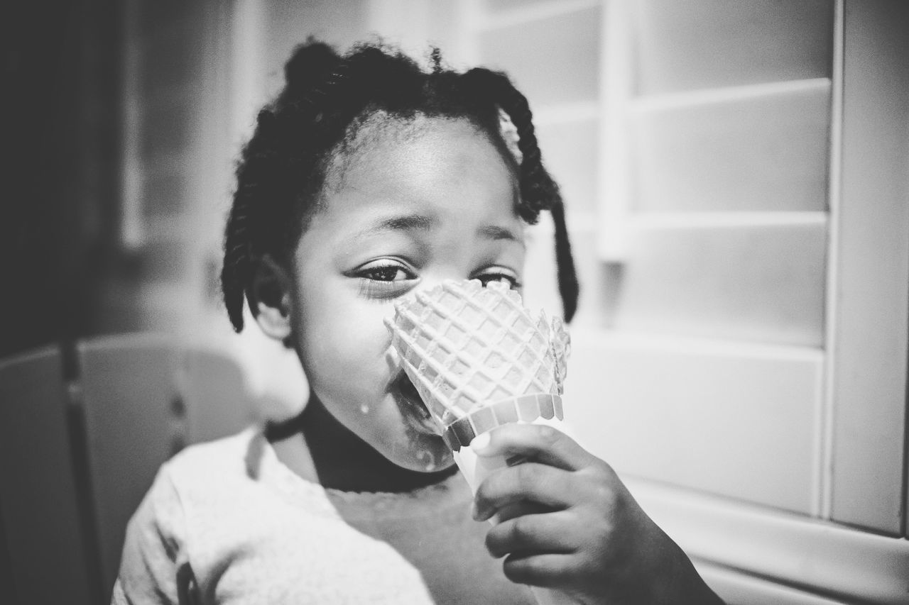 CLOSE-UP PORTRAIT OF BOY HOLDING ICE CREAM IN KITCHEN