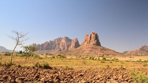 View of rock formations on landscape against clear sky