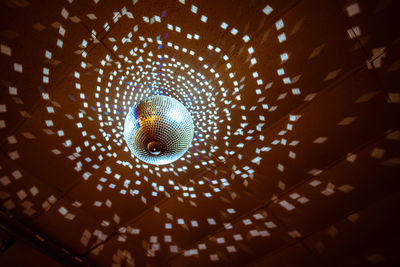 Low angle view of illuminated lights hanging from ceiling