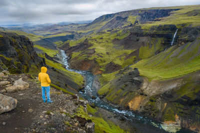 Rear view of man standing on rocks