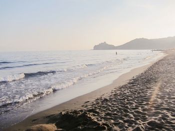 Scenic view of beach against clear sky