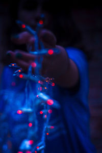 Close-up of hand holding blue lights