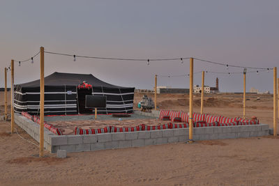 Built structure on beach against clear sky