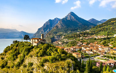 Scenic view of townscape by mountains against sky