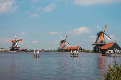 Old dutch windmills in historical village. wooden mills near river. rural holland landmark. 