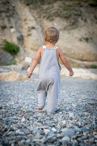 Side view of boy sitting on road