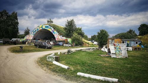Built structure on field by building against sky