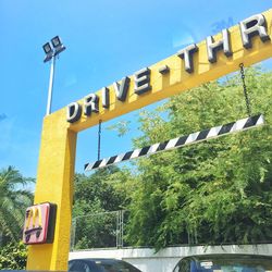 Low angle view of sign board against sky