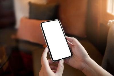 Close-up of hand holding mobile phone