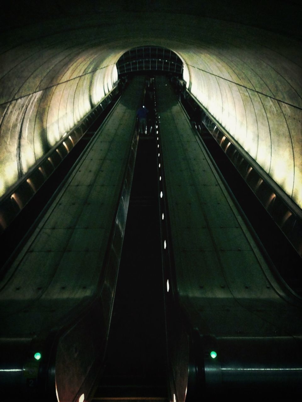 indoors, transportation, rail transportation, railroad track, public transportation, escalator, the way forward, railroad station, diminishing perspective, illuminated, mode of transport, tunnel, train - vehicle, railroad station platform, vanishing point, subway station, travel, ceiling, built structure, architecture