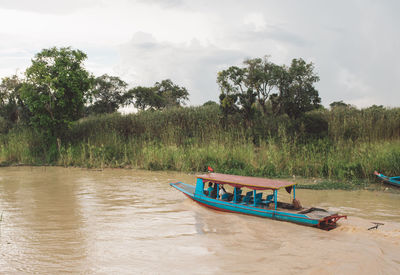 Boat moored at shore against sky