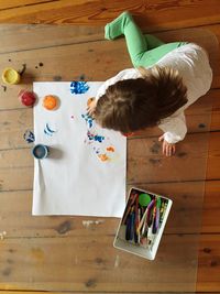 High angle view of child on hardwood floor