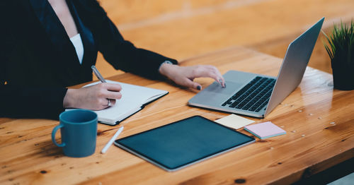 Low angle view of man using laptop on table
