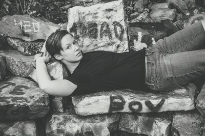 Full length portrait of man on graffitied steps