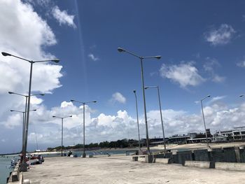 Street by road against sky in city