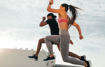 Side view of woman doing yoga on field