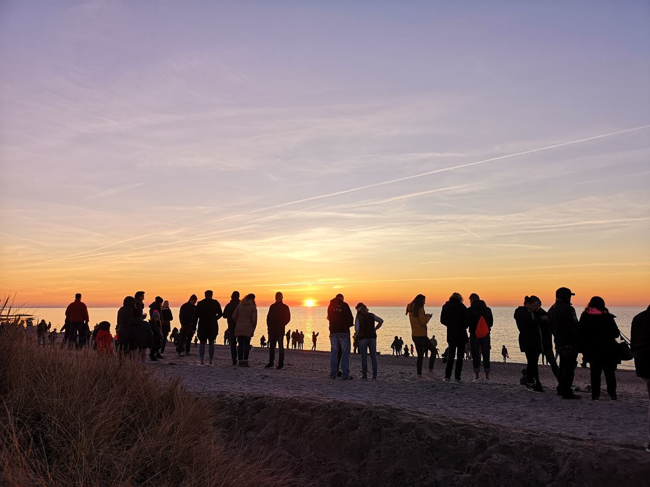 GROUP OF PEOPLE AT SUNSET