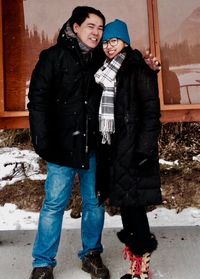 Full length of happy friends standing on snow