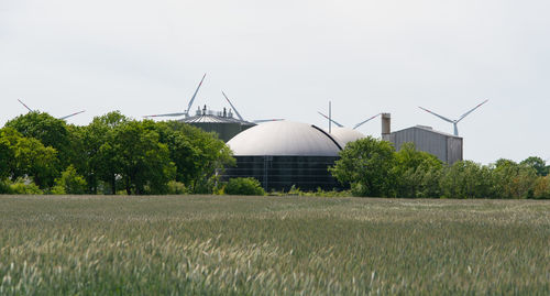 Traditional windmill on field against sky