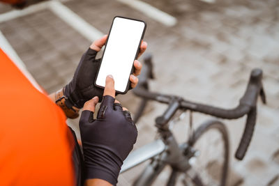 Midsection of man using mobile phone