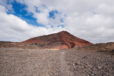 Scenic view of volcanic mountain against sky