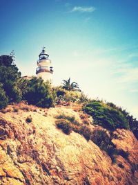 Low angle view of lighthouse against blue sky