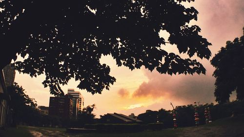 Low angle view of building against sky at sunset