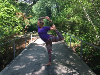 Full length of woman standing on footbridge