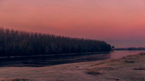 Scenic view of lake against sky during sunset