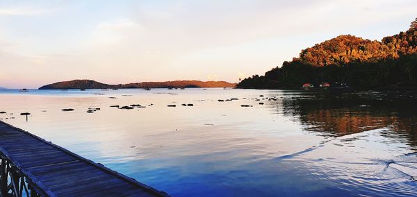 Scenic view of lake against sky during sunset