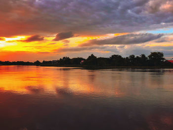 Scenic view of lake against orange sky