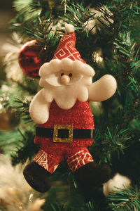 Close-up of christmas decorations hanging on tree