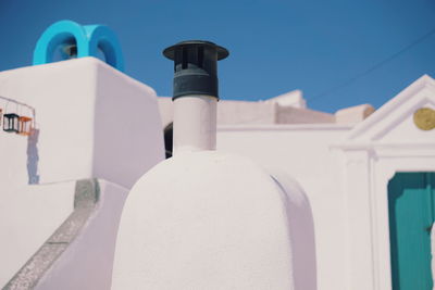 Close-up of white building against blue sky