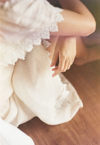 High angle view of woman sitting on hardwood floor