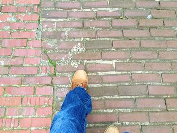 Low section of woman standing on tiled floor