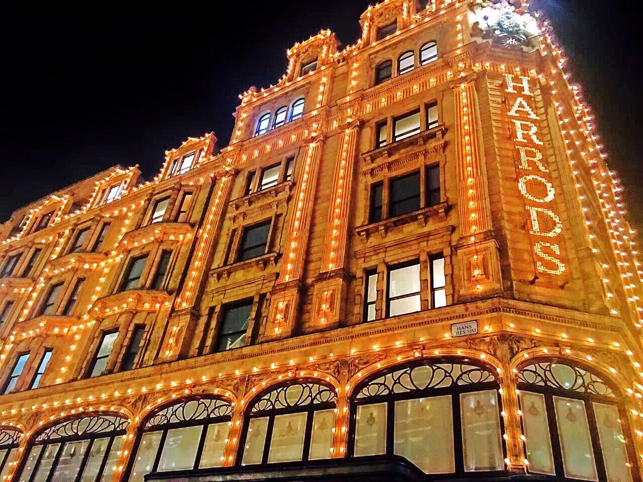 built structure, building exterior, architecture, window, low angle view, night, illuminated, city, arch, in a row, facade, sky, repetition, orange color, outdoors, history, city life, historic, majestic, arched, arcade, townhouse, old town, no people, tall - high