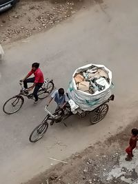 High angle view of people riding bicycle on street