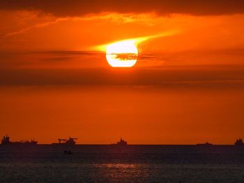 Scenic view of sea against orange sky