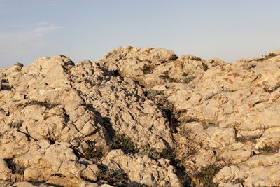 Close-up of rock against sky