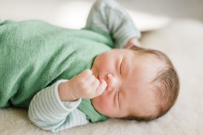 Cute baby boy sleeping on bed