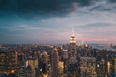 Illuminated cityscape against sky