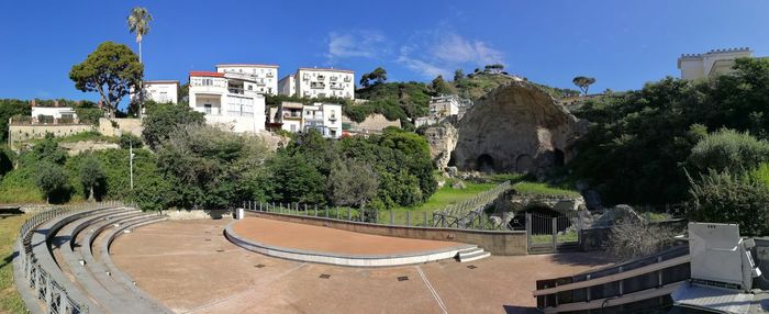 High angle view of buildings against blue sky