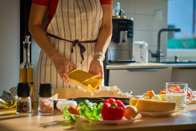Midsection of woman having food on table