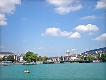 Scenic view of sea and buildings against sky