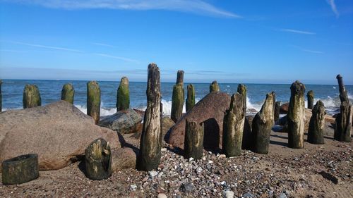 Panoramic shot of rocks on beach against sky