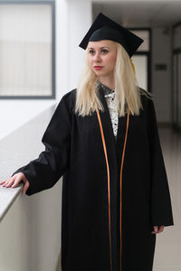 Midsection of woman wearing graduation gown