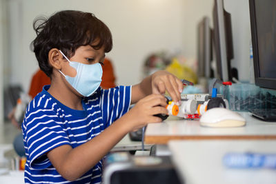 Boy holding ice cream at home