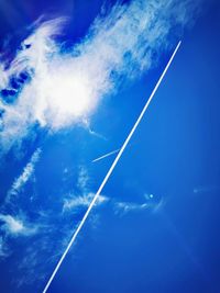 Low angle view of vapor trail against blue sky